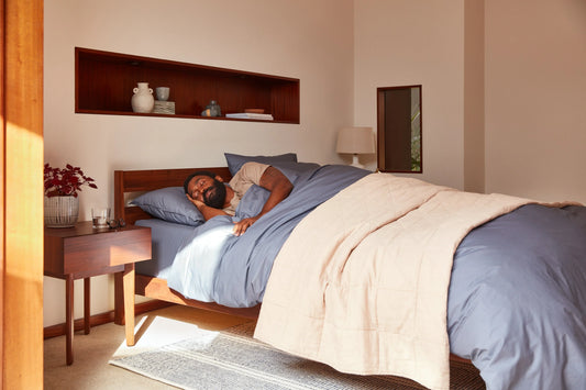 Person sleeping on their side on a Tuft & Needle mattress.