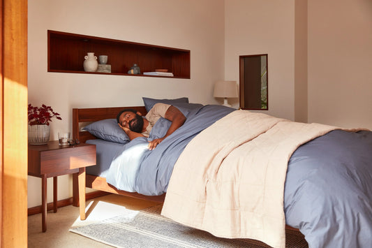 Person sleeping on their side on a Tuft & Needle mattress.