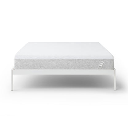 Tuft and Needle Original mattress on a white bed frame against a white background