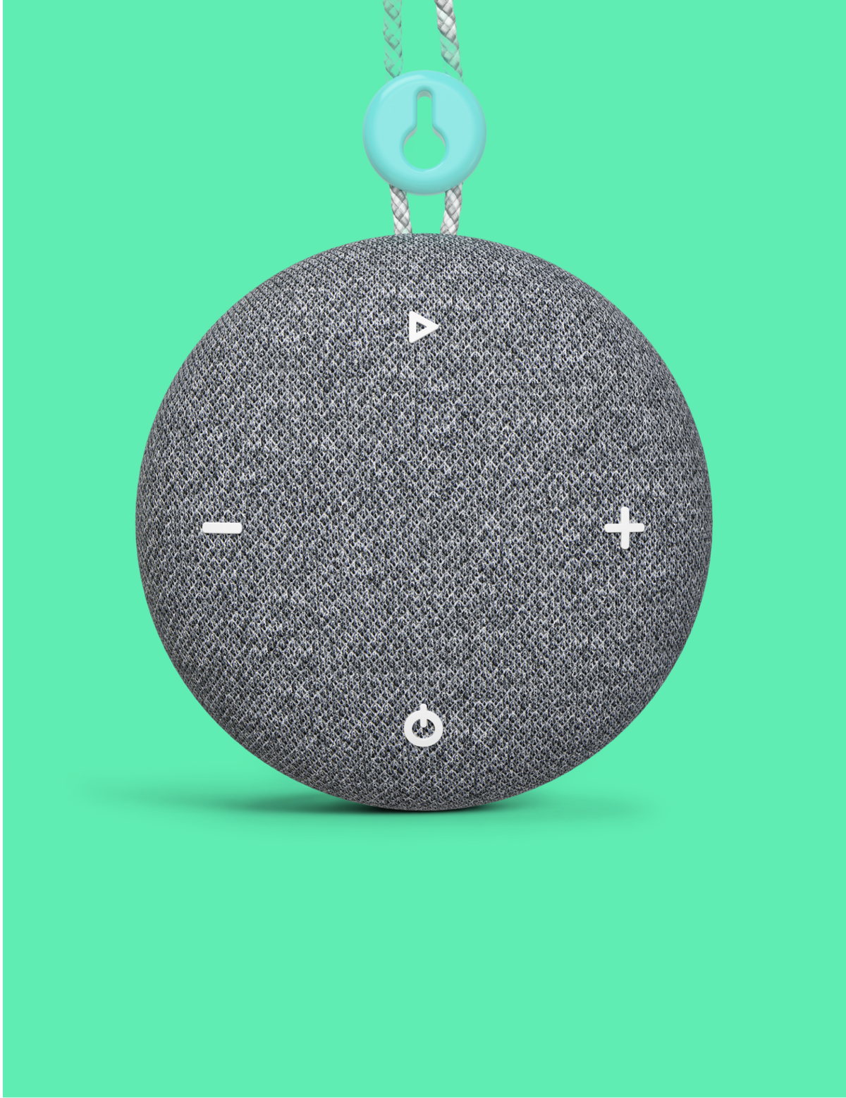 A round gray fabric-covered Tuft and Needle SNOOZ Go 2 Travel White Noise Sound Machine speaker with white control symbols on the front, hanging against a bright mint green background. A light blue key-shaped loop is attached at the top.