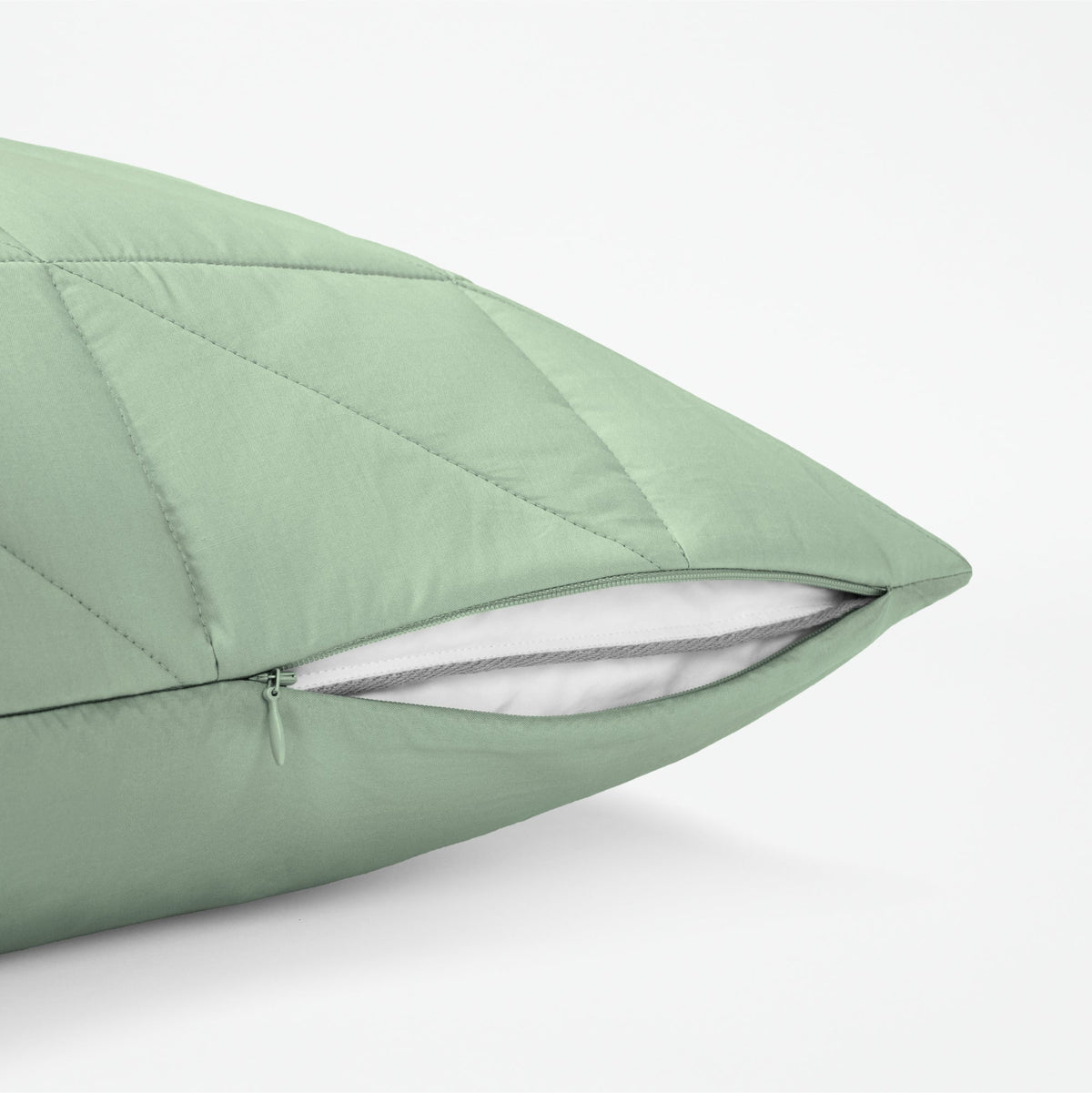 The Tuft and Needle Classic Percale Body Pillow Cover, showing a zipper slightly open to the pillow inside || color: Sage
