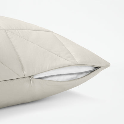 The Tuft and Needle Classic Percale Body Pillow Cover, showing a zipper slightly open to the pillow inside || color: Sand
