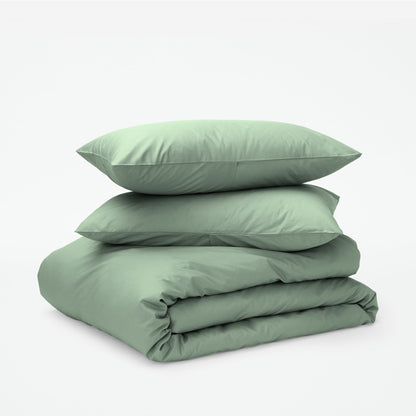 The Tuft and Needle Classic Percale Duvet Set, two pillows stacked on top of a sheet set || color: Sage
