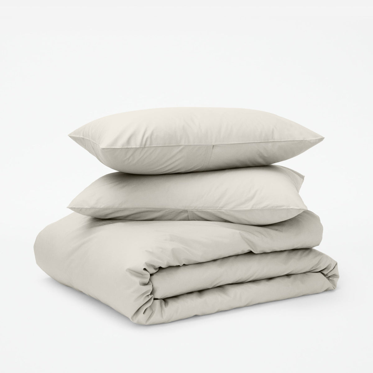 The Tuft and Needle Classic Percale Duvet Set, two pillows stacked on top of a sheet set || color: Sand
