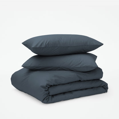 The Tuft and Needle Classic Percale Duvet Set, two pillows stacked on top of a sheet set || color: Slate
