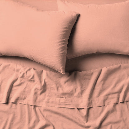 The Tuft and Needle Linen-Cotton Blend Sheet Set, 2 pillows on top of a sheet on a mattress || color: Muted Clay
