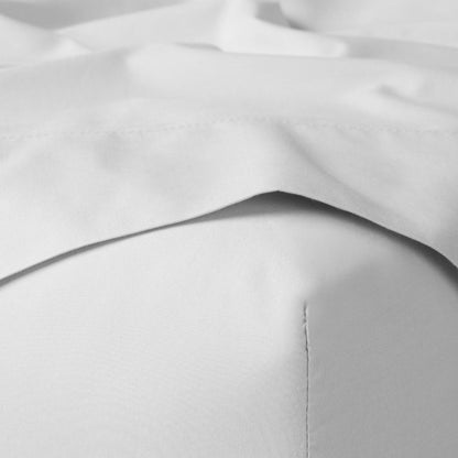 The Tuft and Needle Classic Percale Sheet Set, corner of a mattress with both sheets showing || color: Cloud
