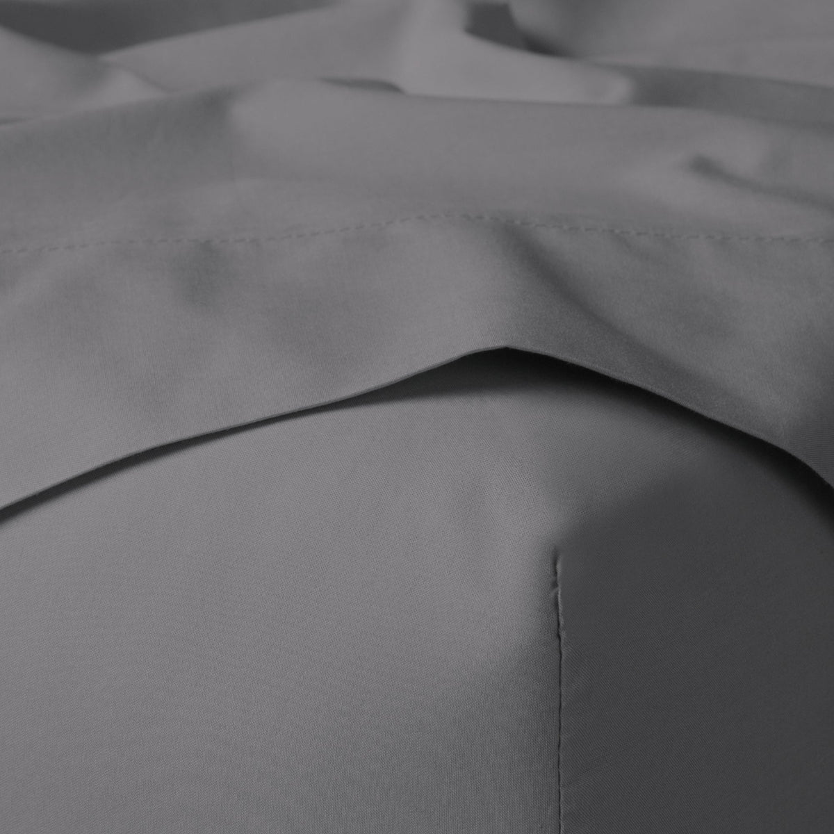 The Tuft and Needle Classic Percale Sheet Set, corner of a mattress with both sheets showing || color: Gray Quill
