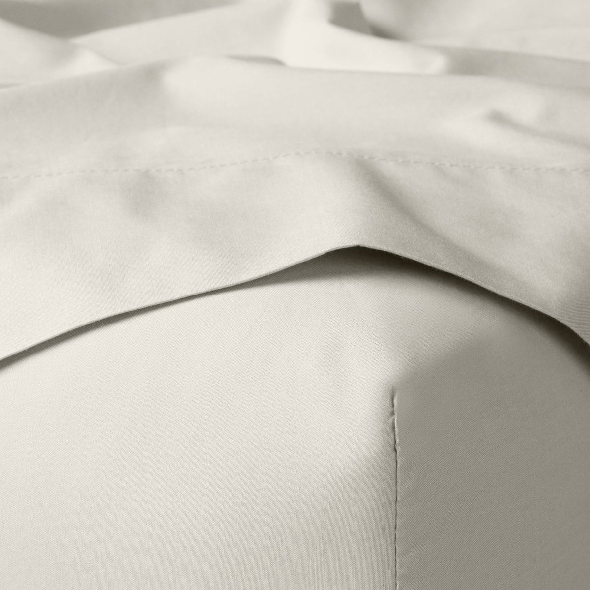 The Tuft and Needle Classic Percale Sheet Set, corner of a mattress with both sheets showing || color: Sand
