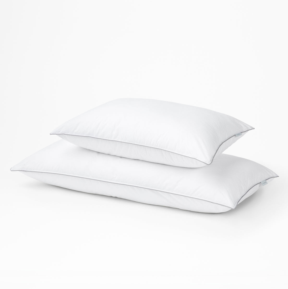 Two Tuft & Needle white pillows on a light gray background