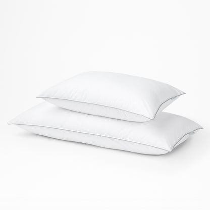 Two Tuft & Needle white pillows on a light gray background