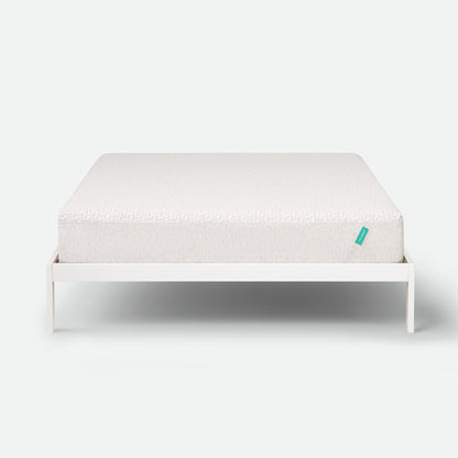 Tuft & Needle White mattress on a white frame with a visible brand logo on a white background