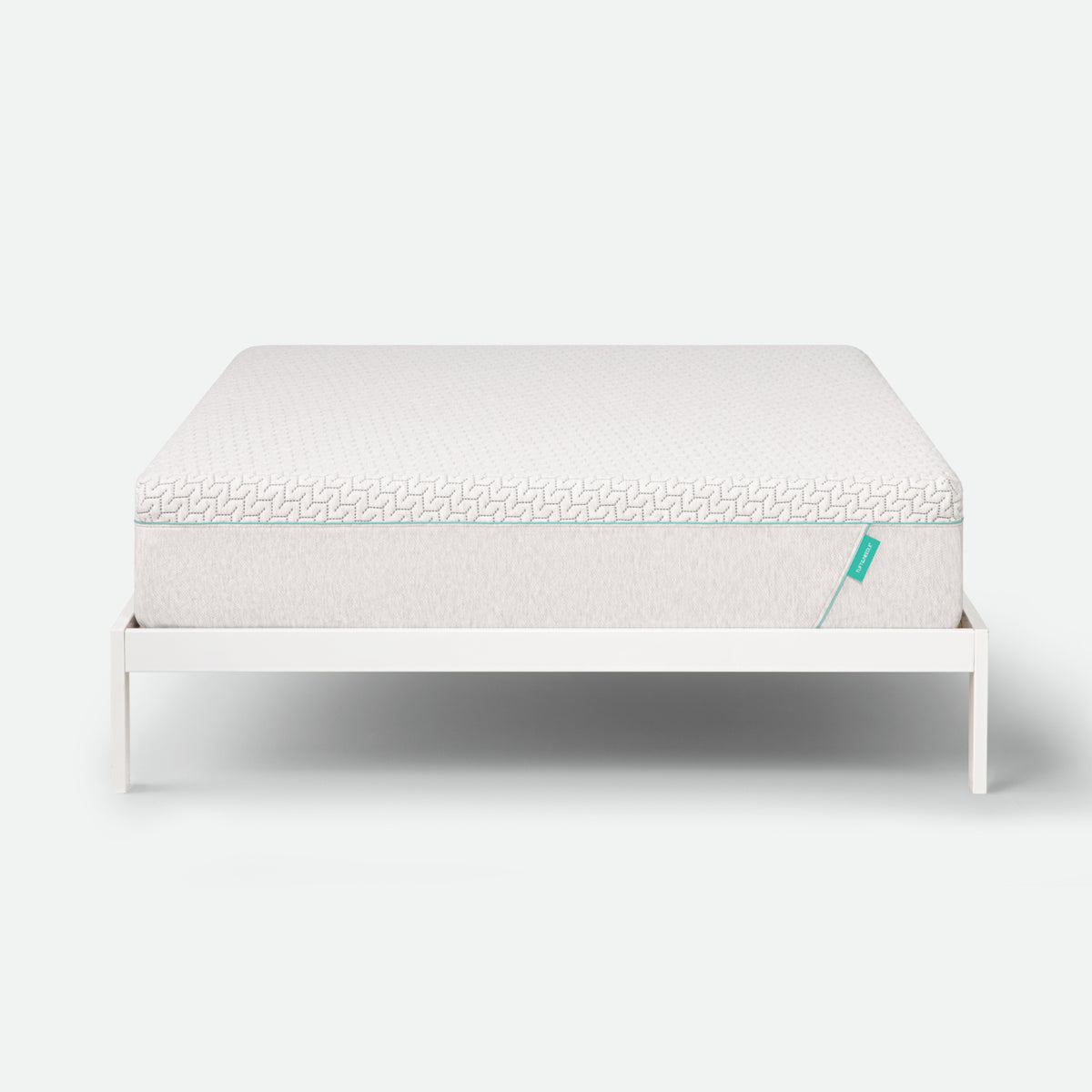 Tuft & Needle Mattress on a white stand with a white background