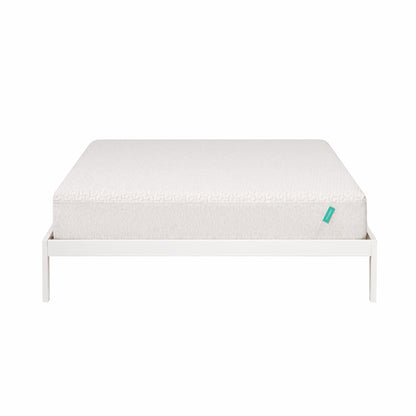 Foam mattress sites on a white bed frame. 