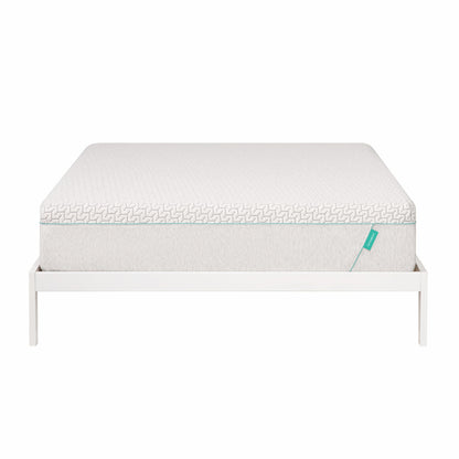 Hybrid mattress sits on white bed frame.