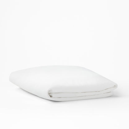 The Tuft and Needle Mattress Protector folded on a white background