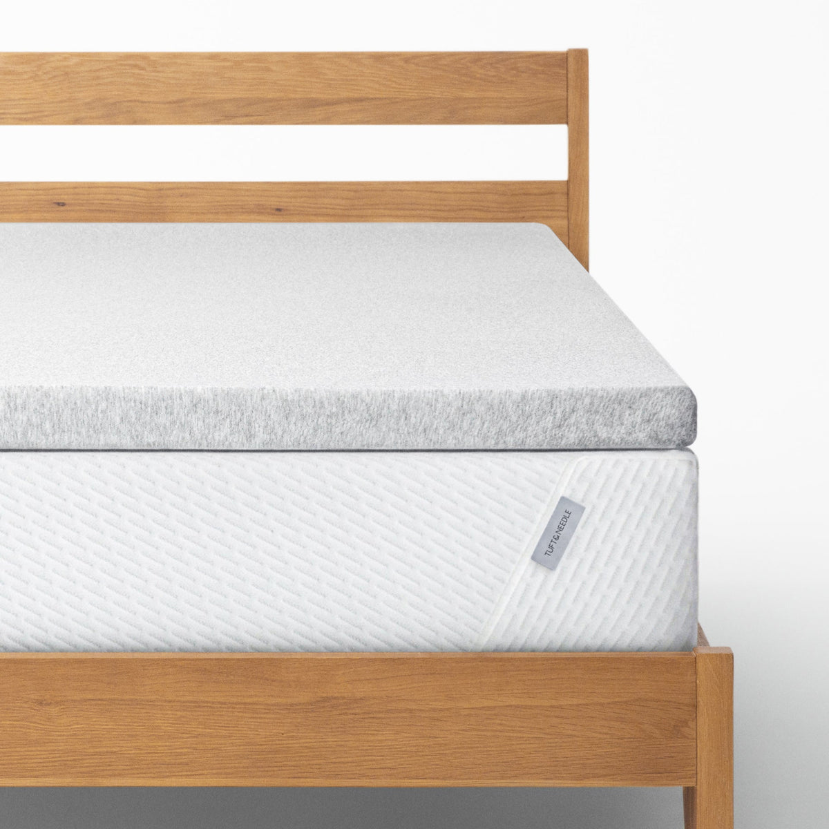 The Tuft and Needle Mattress Topper on a bed