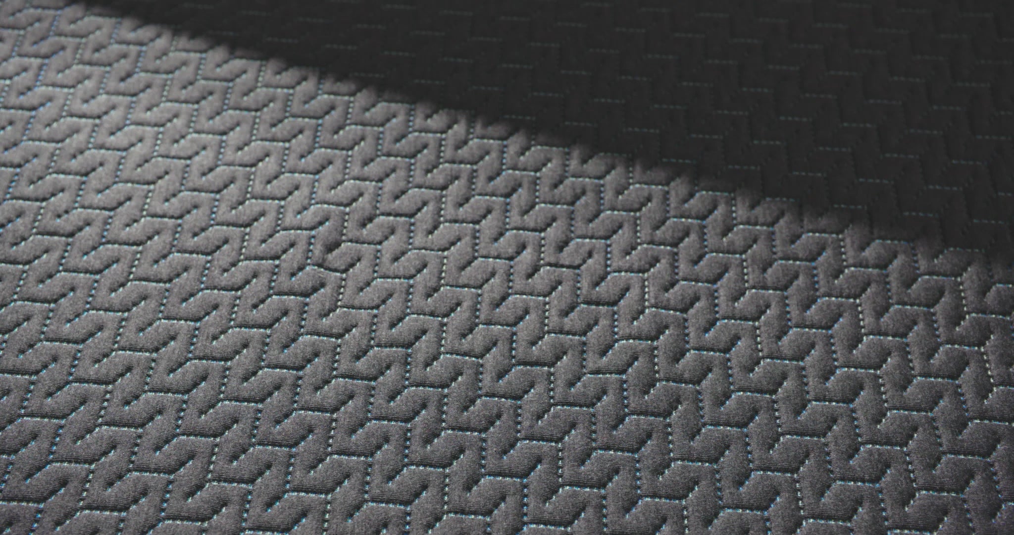 close up of a hand pressing into the top of the 14 inch hybrid mattress