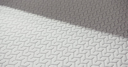 Person presses hand on a foam mattress.
